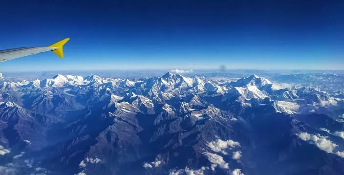 A mountain range seen from an airplane window.